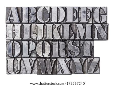 An antique lead letterpress alphabet isolated on a white background.