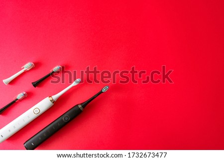 Modern sonic or electric toothbrush set on flat lay background with copy space. Concept of professional oral care and healthy teeth by using smart sonic toothbrush