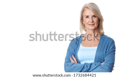 portrait of happy middle-aged female is smiling at camera isolated over white studio wall