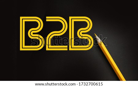 B2B abbreviation yellow on black lettering and yellow pencil besides. Business to business concept.
