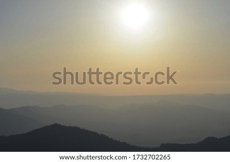 Sunset in the mountains in fog in Russia.
