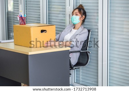 Asian women wear medical masks, store belongings after being laid off due to covid 19 disease Outbreak caused bankruptcy.Lay off and the economy concept. Royalty-Free Stock Photo #1732713908