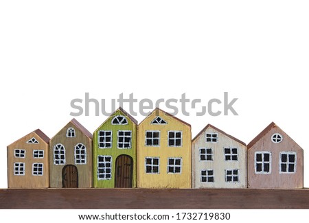 Wooden toy houses on a white background. Miniature town made of wood.