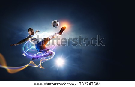 Soccer player on stadium in action. Mixed media