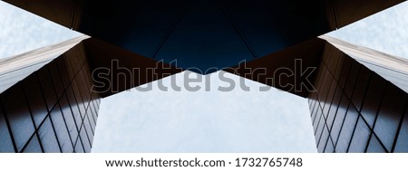 wall and arch of modern tall building against sky and clouds abstract architectural background