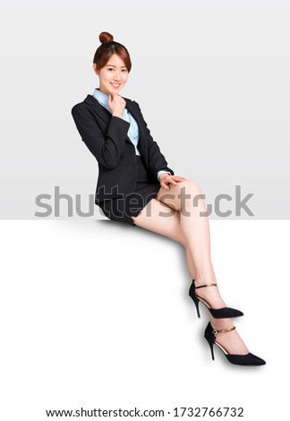young Businesswoman sitting on blank billboard placard sign