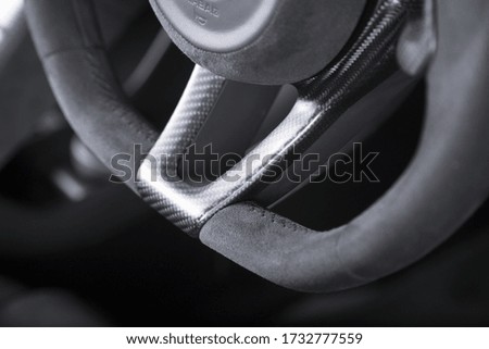 A closeup shot of the steering wheel of a modern car