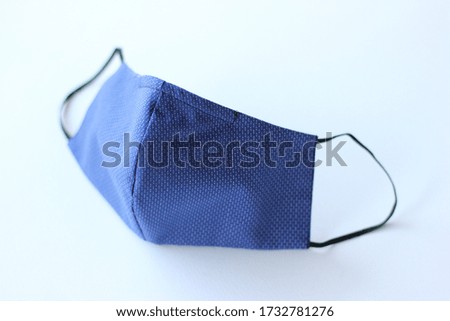Handmade cotton face mask protective against dust and virus top view. Coronavirus preventive cotton mask. DIY concept.

