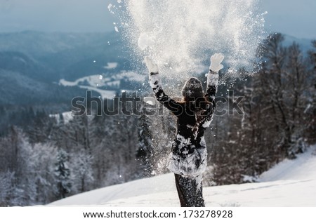 Woman enjoying in snow.