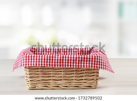 Empty straw basket with red checkered picnic cloth empty space food advertisement design,container.