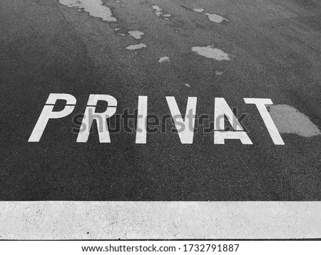 Black and white symbol PRIVAT in German language on the road denote private territory, not public area, Switzerland.