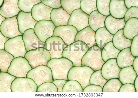 A lot of sliced slices of fresh cucumber in full screen.