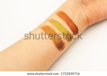 Eye shadow swatches on hand. Colorful shadows good pigmentation. Earthy tones.