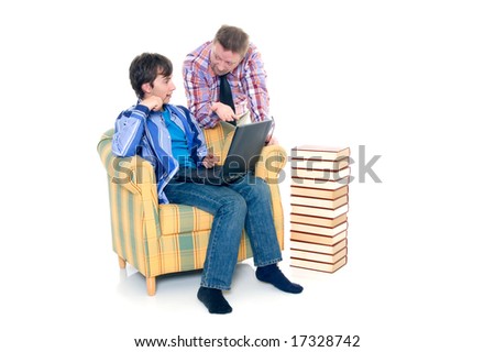 Teenager schoolboy with laptop books on white background