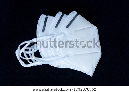 5 layer shear white KN95 FPP2 antivirus medical mask for protection against coronavirus on a black background. Doctor mask prevention of the spread of virus and pandemic COVID-19. 