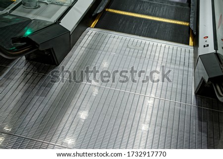 the end of an escalator, lean escalator closeup at the airport. beautiful modern escalator bottom-up view