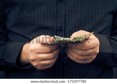A man holds in the hands of Polish money