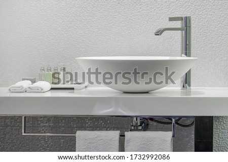 Modern white bathroom sink with faucet. Bathroom interior sink with modern design in luxury hotel.