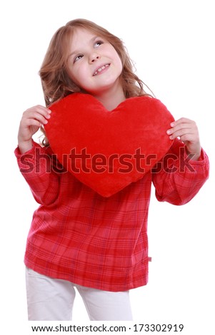 little girl with red heart symbol on Holiday theme/Cute little girl holding a red heart symbol of love and romance on Holiday