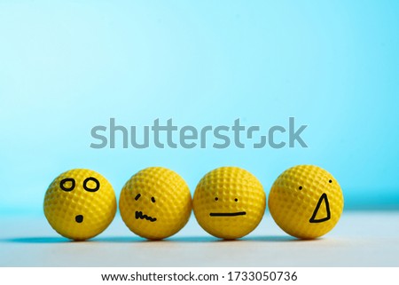
Yellow balls emotions concept on blue background