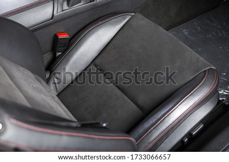 A closeup shot of the black seat inside a passenger car