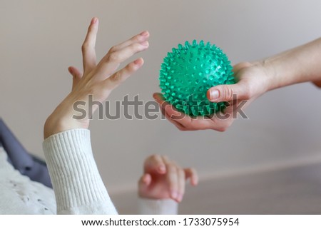 hands of a child with cerebral palsy exercises with a ball development of tactile sensations Royalty-Free Stock Photo #1733075954