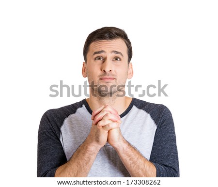 Closeup portrait of young man with open eyes praying looking up hoping for the best asking for forgiveness or miracle isolated on white background. Positive human emotion facial expression feelings