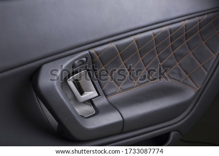 A closeup shot of the door handle of a modern car