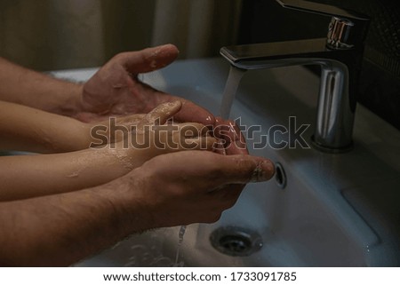 Washing a child’s hands with soap and water to prevent coronavirus and hygiene to stop the spread of coronavirus. wash your hands with soap and hot water 