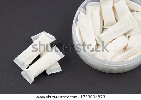 stack snus tobacco pouches over black background. copy space. Royalty-Free Stock Photo #1733096873