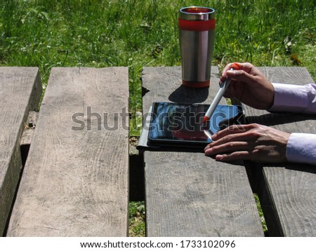 hands of a businessman on a tablet outdoors