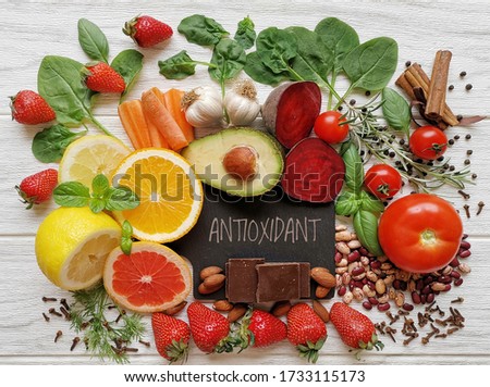 Healthy foods rich in antioxidants. Fresh fruit and vegetable, set of various spices and herbs high in antioxidants. Natural sources of antioxidants. Concept of diet and healthy eating. Royalty-Free Stock Photo #1733115173