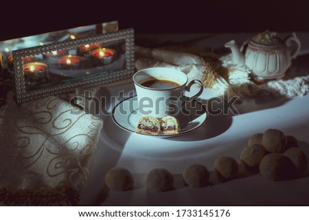 Alexandria, Egypt 17-March, 2020
some cookies of eid- alfitr after the holy month of Ramadan in the morning with a in front of a window light with some candles
