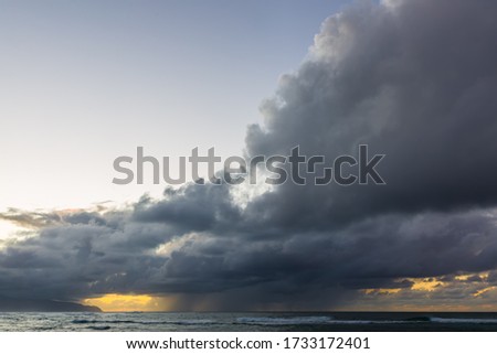 picture of dark clouds at dusk over the sea