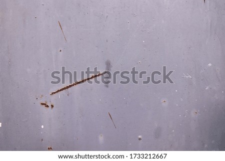 Textured detail of a metal surface with rusty scratches