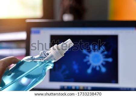 A  girls  is cleaning Notebook computer by alcohol spray