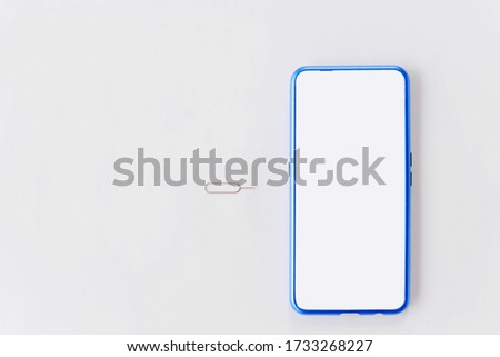 Modern design smartphone with sim card tools, Eject pin sim card tray on white background. Royalty-Free Stock Photo #1733268227