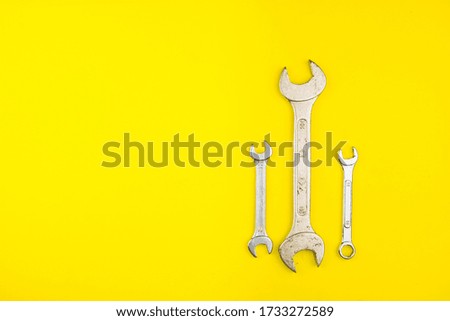 Spanner key on yellow background. Screw driver set. Wrench spanners. Background for your text and design.