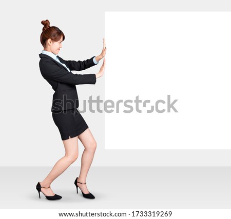 young Business woman pushing big white board