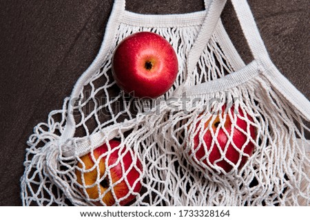 Apples in white eco friendly mesh bag. Zero waste concept