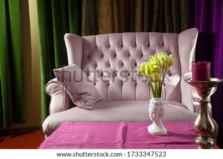 Beautiful luxury stylish and colorful interior scape with pink sofa, curtains and table with flowers