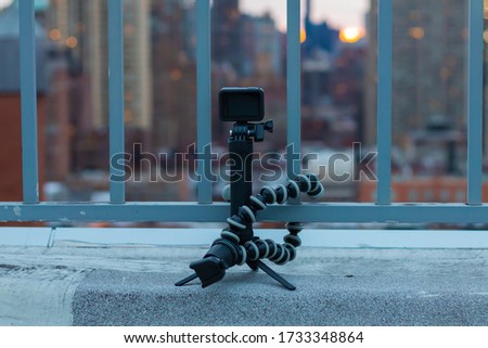 A camera set up with an action cam and a tripod on a rooftop in Manhattan, New York city