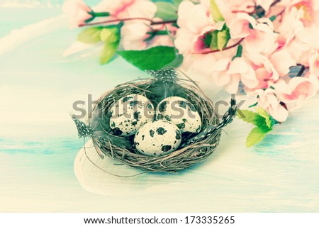 Easter decoration with flowers and eggs in nest. Retro style toned picture