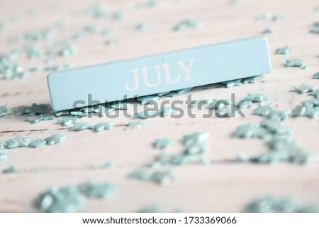 The month of July is written on a wooden bar. Background for the calendar.