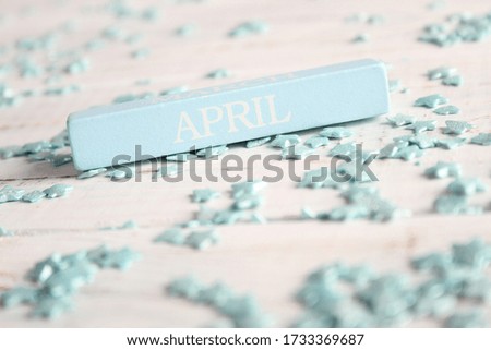 The month of April is written on a wooden bar. Background for the calendar.