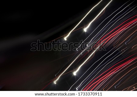 Creative red yellow light trails in dark night backdrop used as abstract background