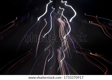 Creative red yellow light trails in dark night backdrop used as abstract background Royalty-Free Stock Photo #1733370917