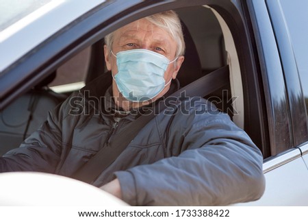 Old man a taxi driver with one-use medical mask, portrait
