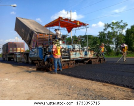 Picture blurred asphalt road construction By using heavy machinery