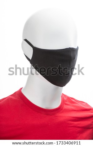 protective face mask against coronavirus on the face of a mannequin, black isolated on a white background